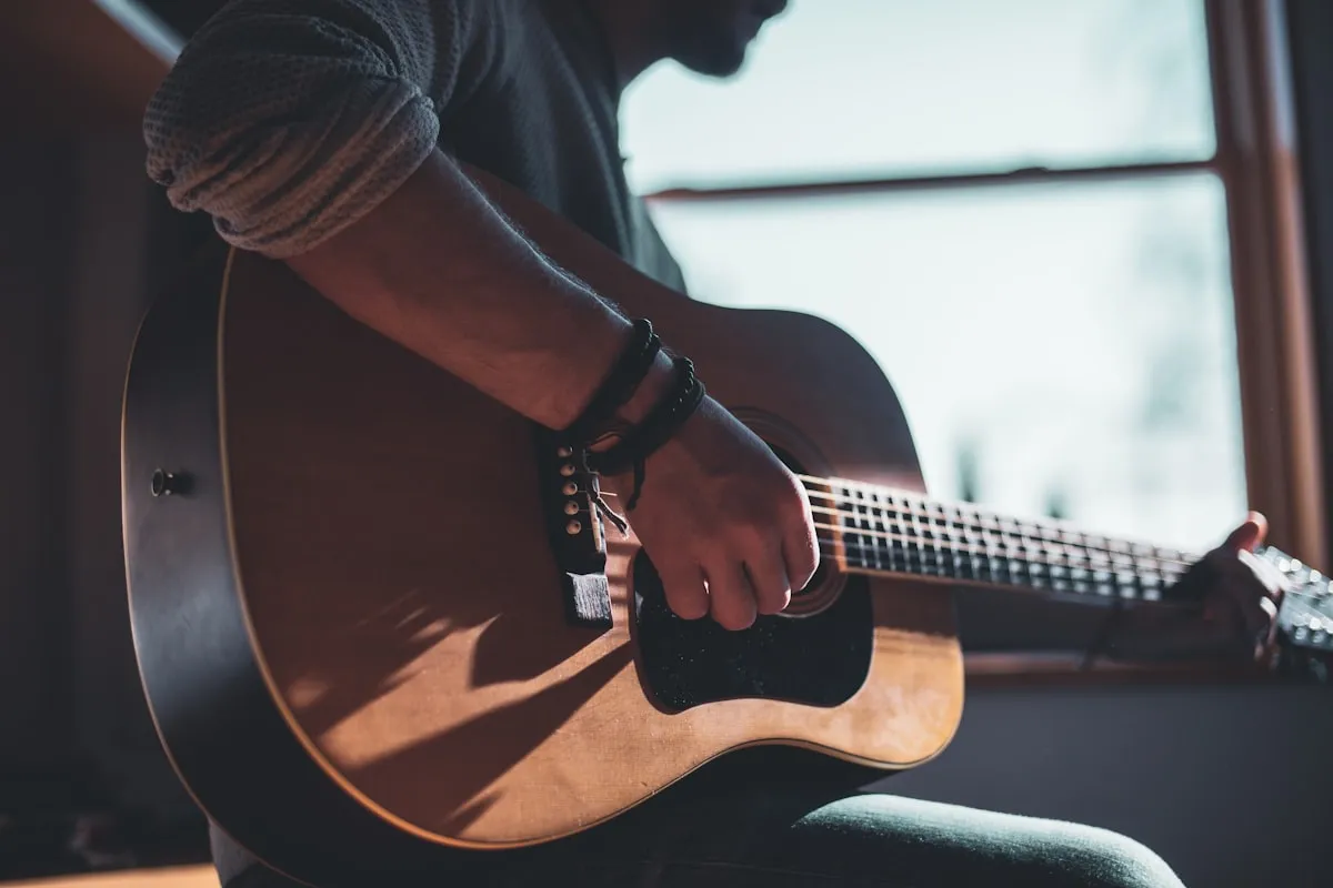 Músico segurando e analisando o violão